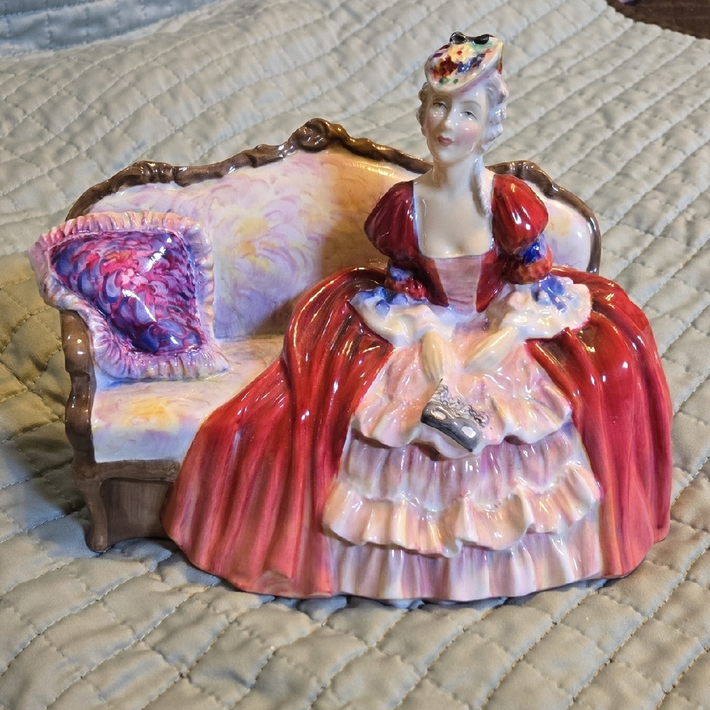 Elegant Red and Pink Figurine on Sofa